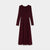 A long-sleeve midi dress in deep burgundy, featuring a round neckline and a pleated skirt, shown against a plain light gray background.
