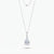 A silver-toned pendant necklace featuring a pear-cut clear gemstone in a prong setting, with a delicate chain and a second layered chain detail at the top, shown on a light gray background.