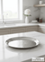 Silver tray on a marble countertop in a kitchen setting