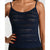 A woman wearing a navy blue open-knit spaghetti-strap tank top, shown from the shoulders to the hips against a plain light background.