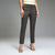 A model wearing a pair of dark gray textured straight-leg trousers, paired with a cream top and beige strappy heels, against a neutral gray studio background.