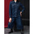 A model wearing a dark blue denim two-piece set consisting of a long-sleeve button-up shirt and matching wide-leg cropped pants, paired with black boots.