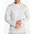 A man wearing a light gray long-sleeve henley shirt with a white crew neck collar and beige pants, shown from the chin down against a plain white background.