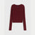 A dark burgundy ribbed knit cardigan sweater with long sleeves and a button-up front, displayed flat against a light gray background.