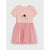 A light pink short-sleeve dress for toddlers, featuring a solid pink top with a cute cat face graphic and bow, and a layered pink tulle tutu skirt, shown against a light gray background.