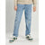 A person wearing light-wash blue distressed jeans with a beige sweatshirt and green-and-white sneakers, shown from the chest down against a light gray studio background.