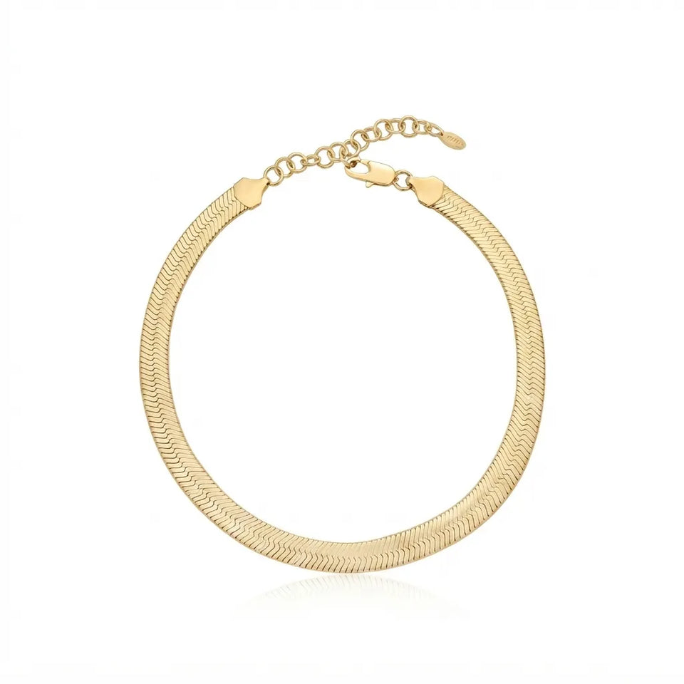 A gold-toned snake chain choker necklace with a lobster clasp and extender chain, displayed on a clean white background.