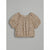 A short-sleeve baby tee with a leopard print pattern in beige, brown, and black, featuring a ruffled off-the-shoulder neckline and puff sleeves, shown flat on a gray background.