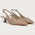 A pair of pointed-toe slingback pumps in a light nude beige color, featuring a low block heel and a small gold-tone buckle on the slingback strap, shown against a plain light gray background.
