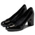 A pair of black patent leather pumps with a block heel and a wide elastic side strap, shown on a white background.