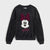 A black crewneck sweatshirt featuring a sequined Minnie Mouse face graphic on the front, with a sparkling pink bow and 'Boo' text below, displayed against a light gray background.