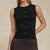 A sleeveless black knit top with a row of gold buttons down the front, worn by a model against a warm beige background.