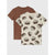 Two short-sleeve kids' t-shirts displayed as a layered set. The front shirt is cream-colored with an all-over print of vintage brown cars and text reading 'SNOOZE HAPPY'.