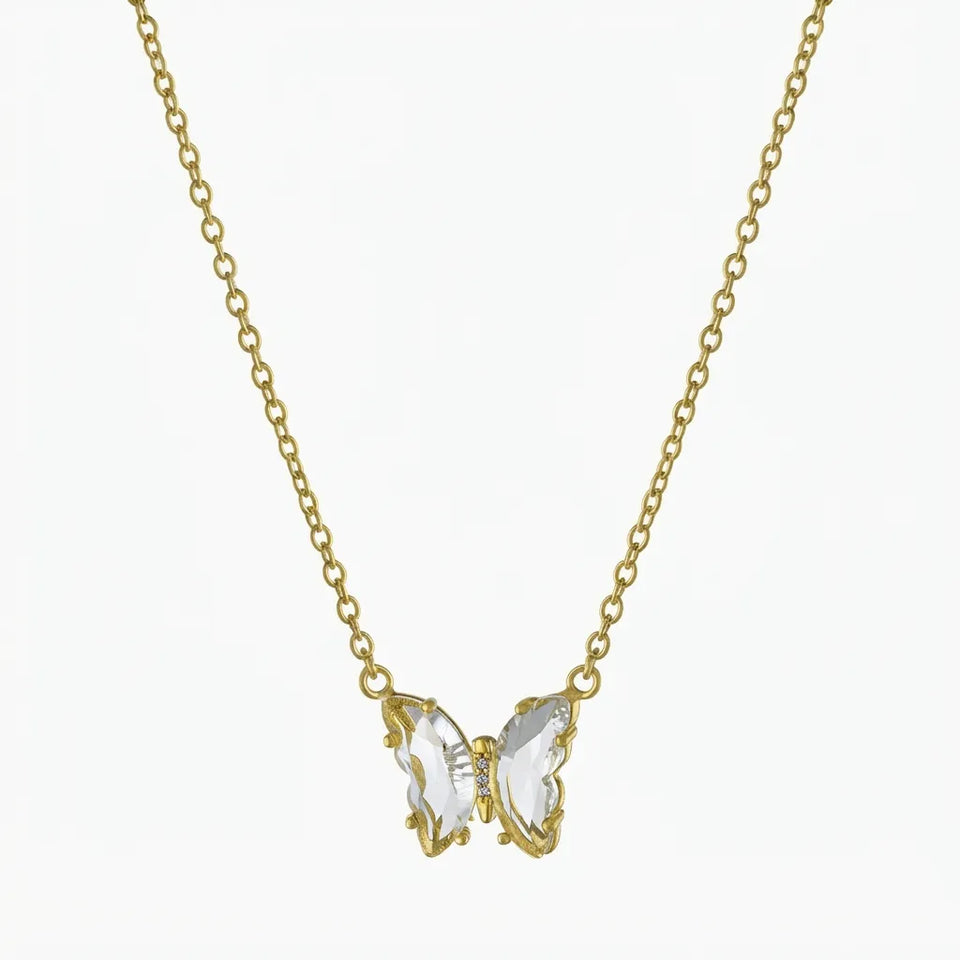 A delicate gold chain necklace featuring a butterfly pendant with clear, faceted crystal wings set in gold, shown against a plain white background.