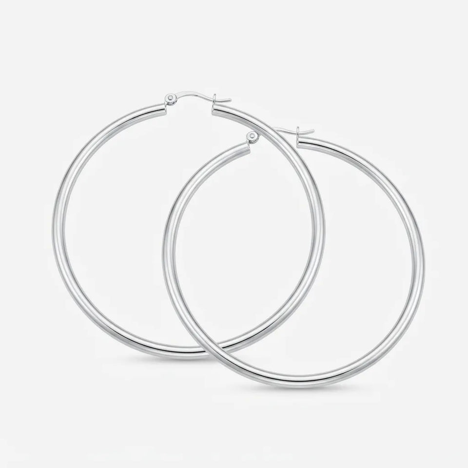 A pair of polished silver hoop earrings with a thick, rounded tube design and secure fishhook closures, displayed on a clean, light gray background.