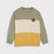 A color-blocked crewneck sweatshirt with a sage green top section, a wide cream middle stripe, and a mustard yellow bottom section, featuring a small brown circular patch on the left chest.