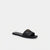 A black quilted leather slide sandal with a small gold-tone metal emblem on the strap, shown against a plain white background.
