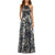 A sleeveless halter-neck floor-length gown with a metallic silver base and a dark navy floral pattern, shown on a model against a plain white background.