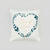 A square white throw pillow featuring a printed heart-shaped floral wreath in dark teal and gold, with the words 'Time of Love' in gold script in the center, shown against a neutral light gray background.