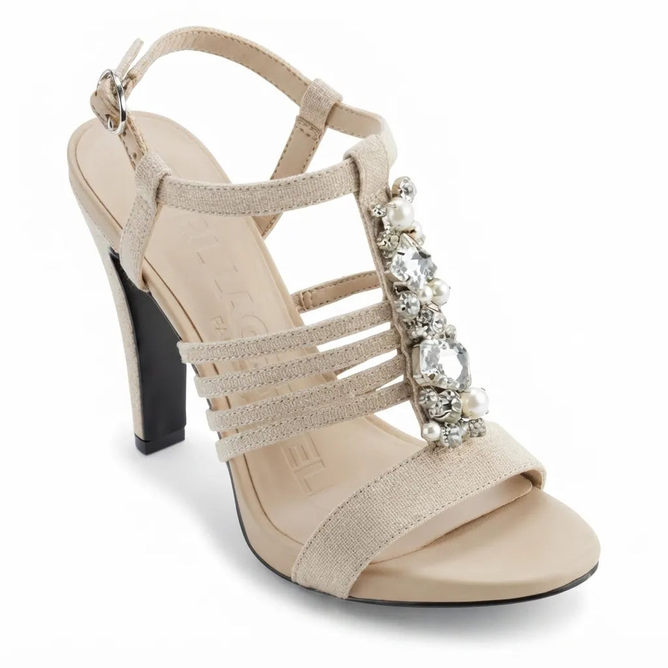 A single women's high-heeled sandal in a light beige suede-like material, featuring multiple thin straps, a black block heel, and a prominent embellished strap with clear rhinestones and white faux pearls.