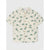 A short-sleeve button-up shirt for kids in an off-white base color with an all-over green dinosaur and plant print, featuring brown buttons and a chest pocket.