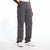 A person wearing dark gray cargo pants with side flap pockets, paired with a white top and white sneakers, shown from the waist down against a white studio background.
