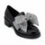 A black patent leather loafer with a chunky block heel and a large black and white houndstooth bow on the toe, shown against a plain white background.