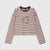 A cropped long-sleeve top with horizontal burgundy and cream stripes, featuring a matching burgundy crew neck and cursive embroidered text on the chest, displayed on a light gray background.