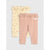Two pairs of baby leggings from the brand Kith Kids, displayed flat against a light gray background. The front pair is dusty pink with a ruffled waistband and elastic cuffs, while the back pair is cream yellow with a small cherry print and matching ruffles.