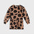 A long-sleeve babydoll dress in brown velvet with a black leopard print pattern, shown flat on a light gray background.