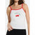 A woman wearing a white spaghetti-strap tank top with red trim and a cherry graphic on the chest, paired with black bottoms, against a plain white background.