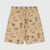Beige swim shorts with an all-over black line-art print of surfboards, palm trees, sunglasses, and skulls, shown flat against a light gray background.