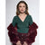 A woman modeling a dark green long-sleeve top with a twisted V-neck and a deep burgundy faux fur jacket draped over her shoulders, paired with a matching textured skirt.
