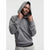 A man wearing a textured gray knit hoodie with a black ribbed hem, posing against a light gray background.