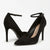 A pair of black pointed-toe high heels with ankle straps, shown on a clean white background. The shoes feature a matte black finish, with the brand name 'GUESS' visible on the insole.