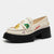 An off-white platform loafer shoe with a chunky black sole and block heel, decorated with colorful cartoon patches and embroidered text including 'LOVE' and 'APPLE'.