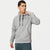 A man wearing a heather gray Nike pullover hoodie with black drawstrings and a black swoosh logo on the chest, paired with dark gray athletic pants, against a plain light gray background.
