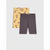 A pair of dark gray heathered bike shorts laid flat, with a matching pair of yellow leggings featuring a brown cat pattern tucked behind them on a light gray background.