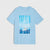 A light blue short-sleeve crewneck t-shirt featuring a rectangular graphic print on the front with a sailboat on blue water and the text 'BORN TO SAIL' in white.