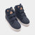 A pair of navy blue high-top children's sneakers with white soles and a plush teddy bear face detail on the collar, shown on a light gray background.