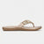A single women's flat thong sandal in a metallic champagne gold color, featuring a wide strap embellished with clear rhinestones and a small gold heart at the center, shown in profile against a light gray background.