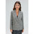 A woman modeling a gray and white plaid double-breasted blazer with black leather pants, set against a plain light gray studio background.