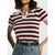 A woman wearing a short-sleeve polo shirt with horizontal burgundy and cream stripes, tucked into blue jeans with a black belt.