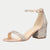 A single women's heeled sandal with a block heel, ankle strap, and open toe, covered in sparkling rhinestones. The upper and heel are a champagne rose gold tone, while the insole is a light nude beige.