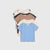 A stack of four children's short-sleeve t-shirts in different colors: light blue, beige, brown, and navy, with some shirts featuring small printed graphics, laid out on a light gray background.