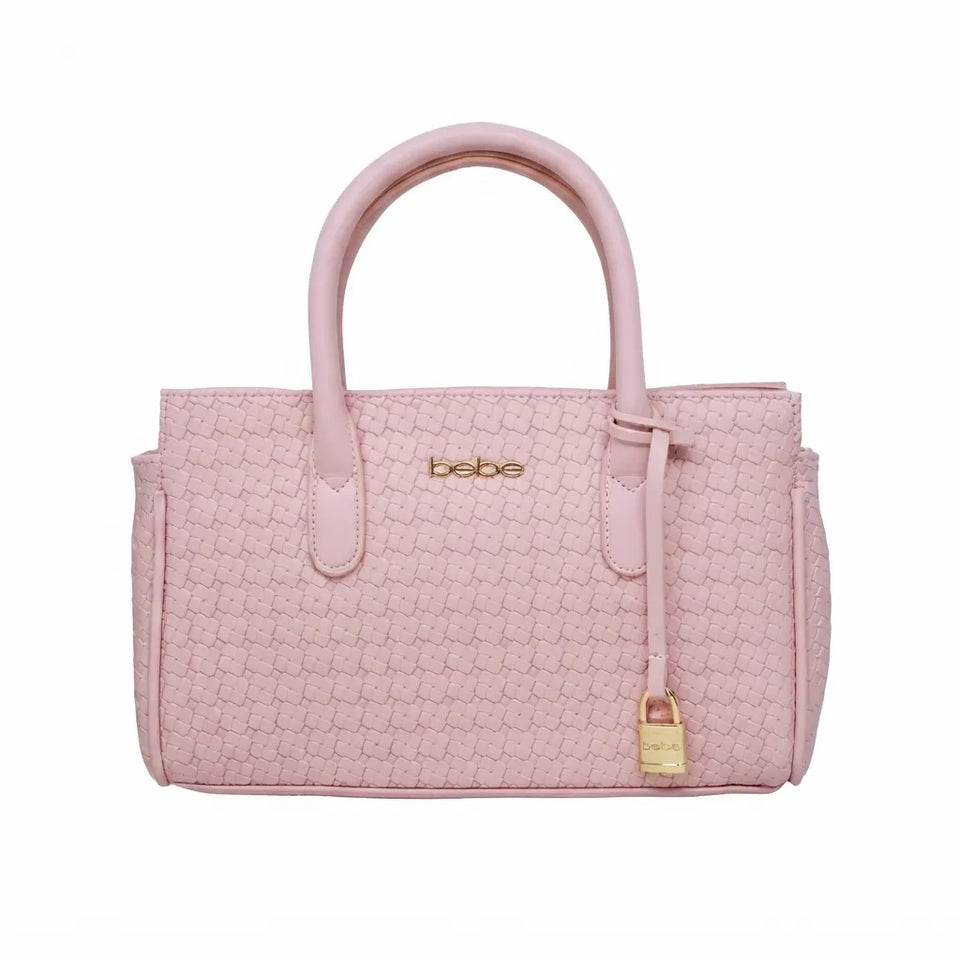 A light pink textured leather handbag with double top handles, a hanging gold padlock charm, and the brand name 'bebe' in gold lettering on the front, set against a plain white background.