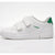 A white low-top children's sneaker by Hummel with two hook-and-loop straps, green logo text, and a green heel accent, shown in a side profile on a white background.