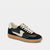 A low-top sneaker in black leather and suede with cream accents, featuring a cream side logo, cream laces, and a tan gum sole, shown against a light gray background.