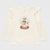 An off-white long-sleeve baby tee with ruffled shoulder details and a central Christmas snow globe graphic featuring a reindeer and the words 'Christmas Princess'.