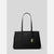A black leather tote bag with double shoulder straps, featuring a gold-tone MK logo charm and a small gold logo plaque on the front, set against a light gray background.